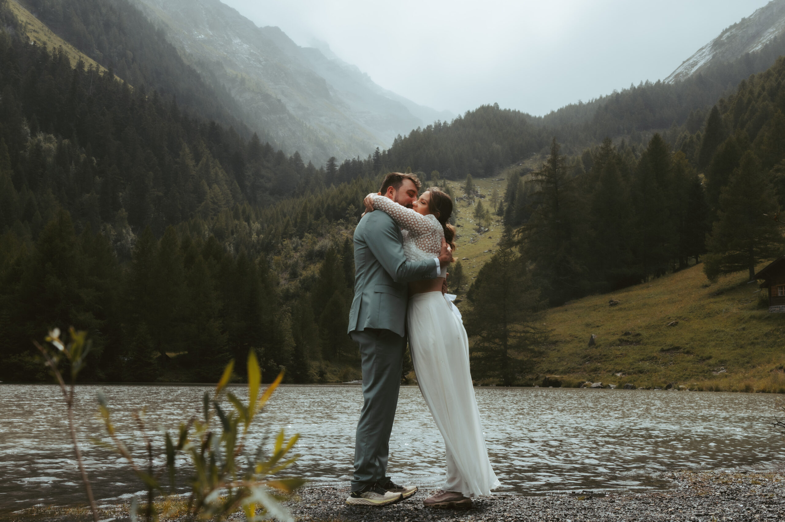 A bride hugs her groom during their elopement in the swiss alps