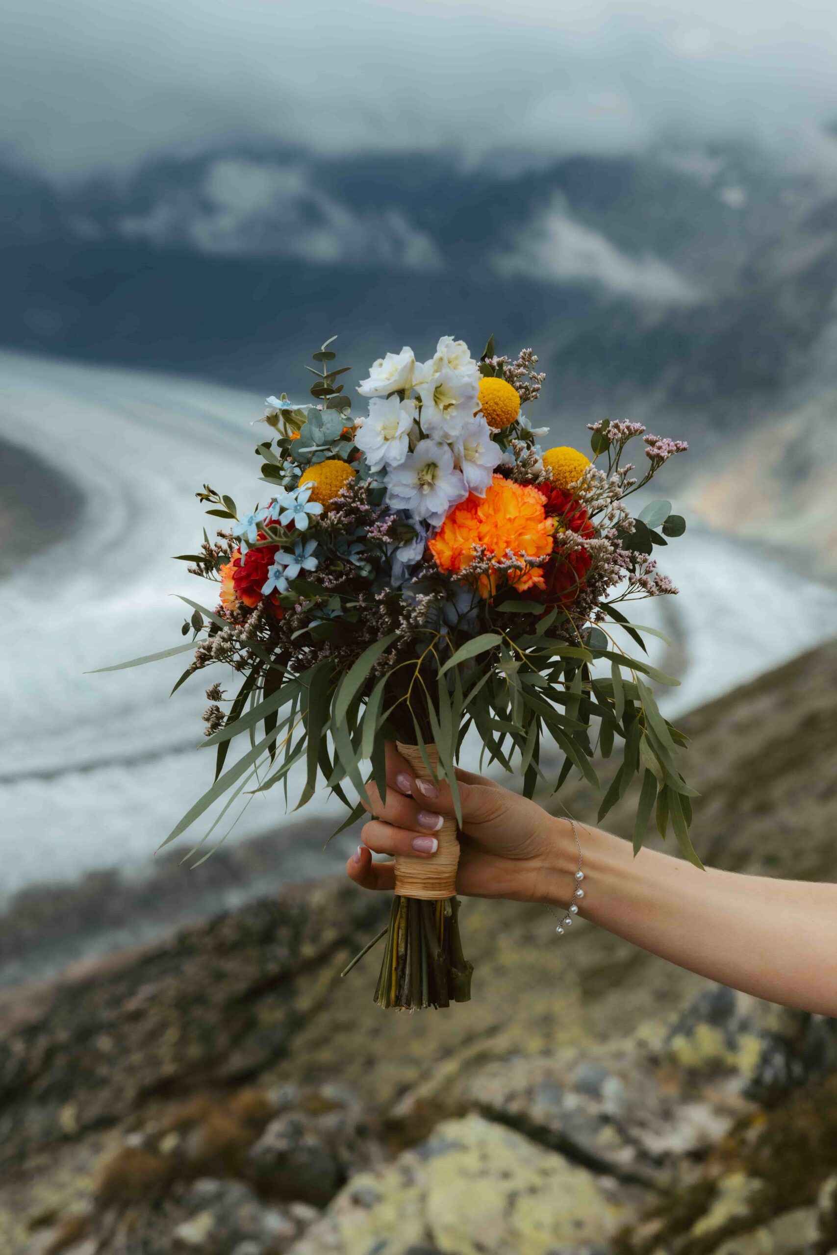 Flower bouquet in front of mountains and a glacier