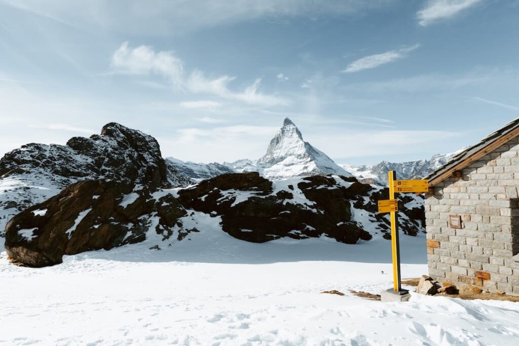 Matterhorn in front of snowy lake and mountain trail