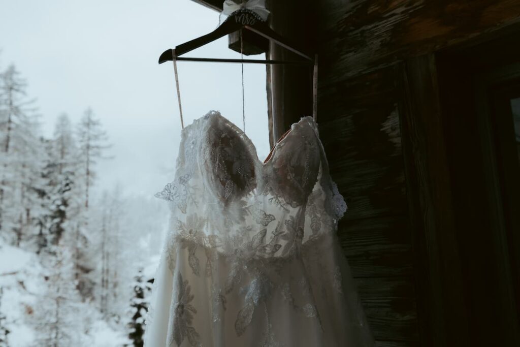 Bride's elopement dress hanging on a hotel in Zermatt in winter
